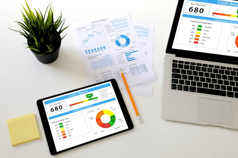 A man looking at his free credit report on a laptop