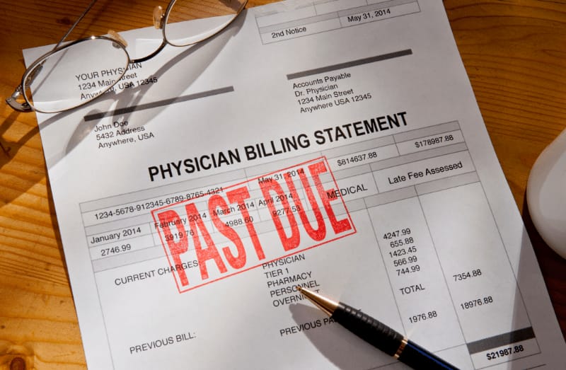 A person looking at their credit report, showing medical debt