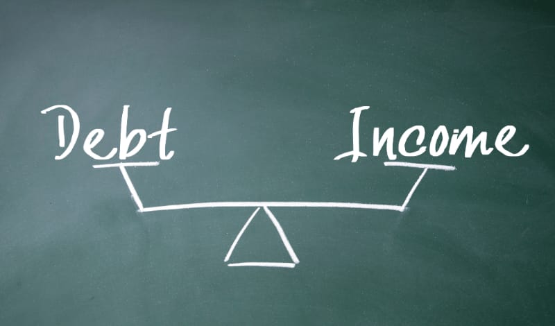 A person monitoring and maintaining a healthy debt to income ratio