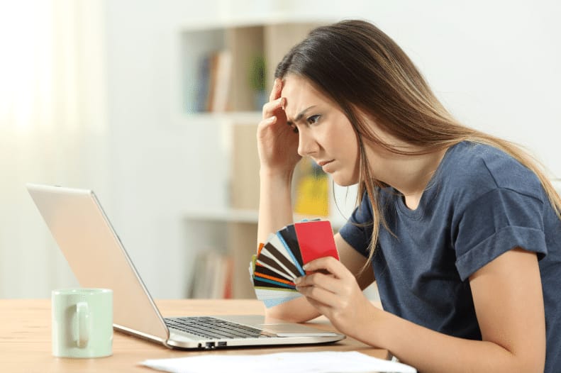 person holding multiple credit cards